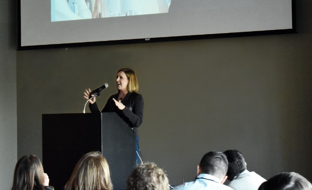 Jennifer Davis speaking at a podium